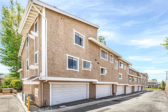 View of a multi-story residential building with garages.