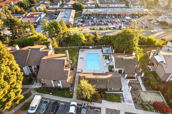 Aerial view of residential buildings surrounding a central swimming pool.