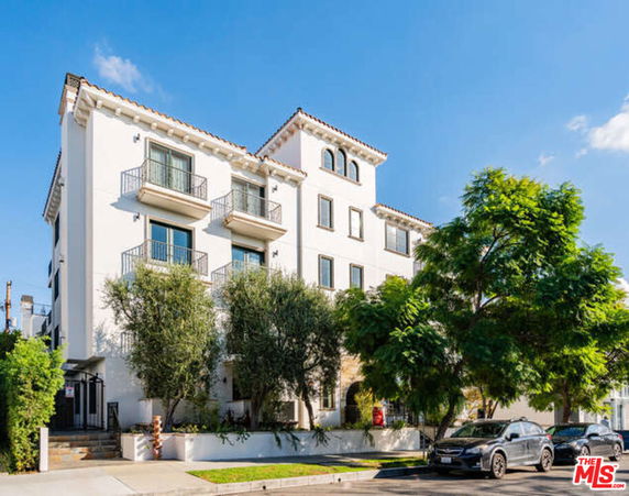 Front view of a multi-story apartment building with balconies.