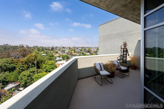 Balcony with seating and a view of the surrounding area.