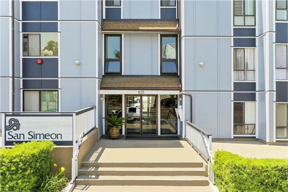 Front view of a building with a main entrance and the name San Simeon.