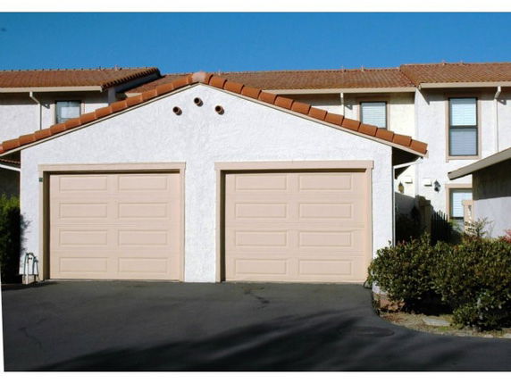Front view of a house with a double garage and a tiled roof.
