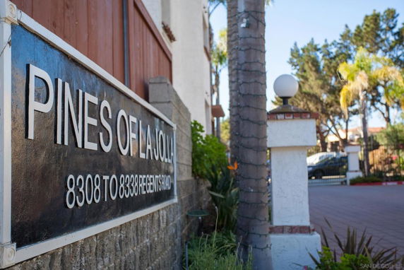 Entrance of a residential complex with signage displaying the name and address.