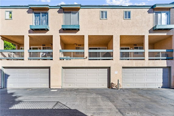 Front view of a multi-story building with multiple garage doors.