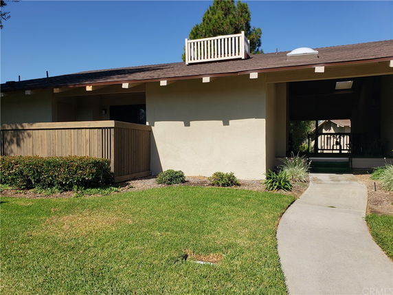 Front view of a single-story house with a walkway and small porch.