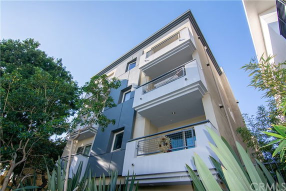 Front view of a multi-story residential building with balconies.