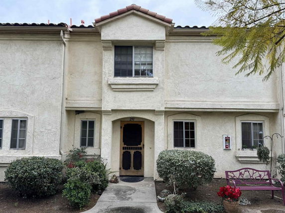 Front view of a two-story house with multiple windows and a central entrance.