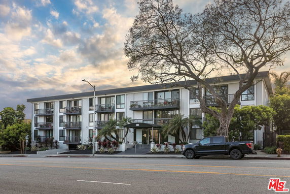 Front view of a multi-story residential building with balconies.