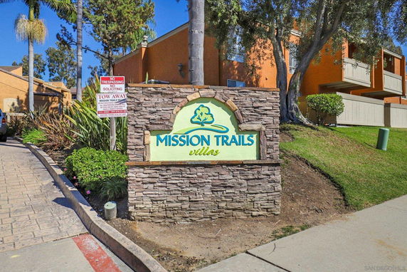 Front view of a building with a sign reading 'Mission Trails Villas'.