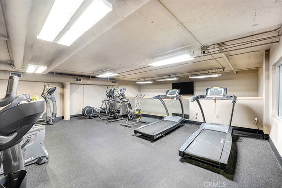 Indoor gym area with treadmills and exercise machines.