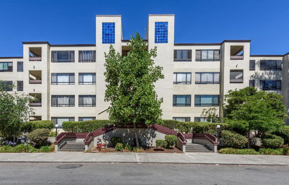 Front view of a multi-story residential building with balconies.