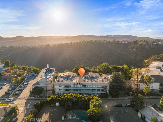 Panoramic view of a residential area with hills in the background.