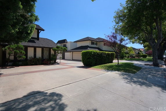 Front view of two modern two-story houses with garages.