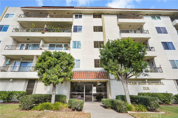 Front view of a multi-story building with balconies.
