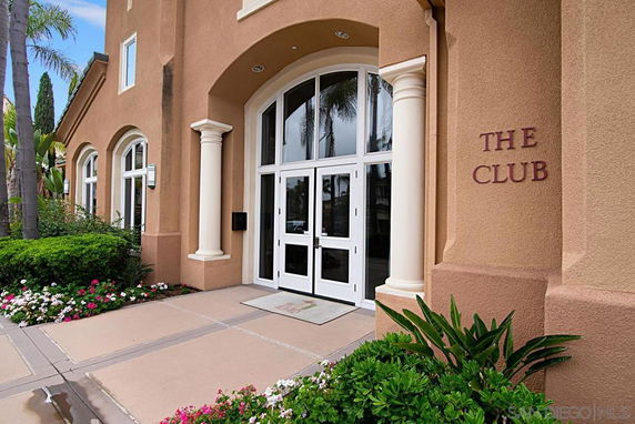Front view of a building entrance labeled 'The Club' with arched windows and columns.