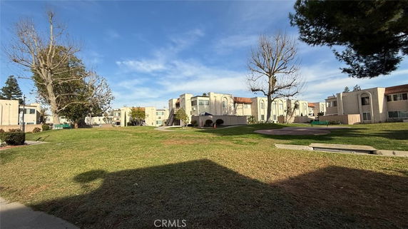 View of a residential area with multi-story apartment buildings and surrounding grassy areas.