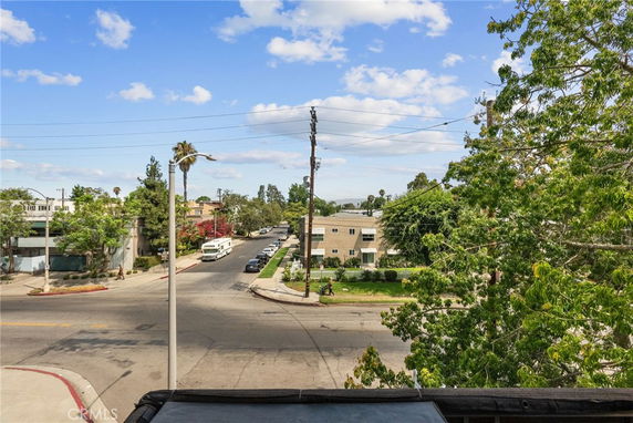 Street view with a multi-story building and trees