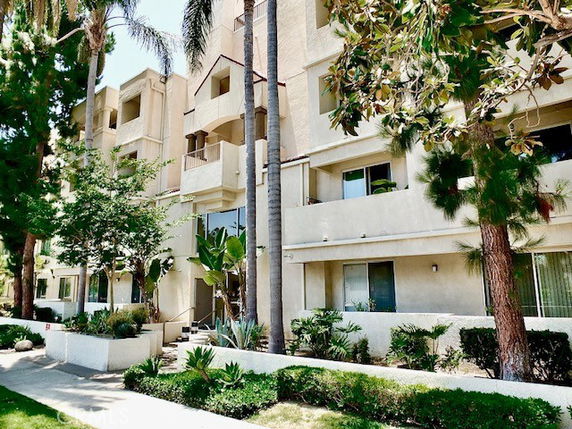 Front view of a multi-story residential building with balconies.