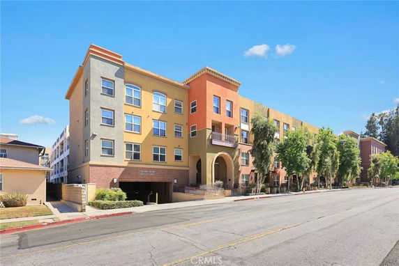 Front view of a multi-story apartment building with a colorful facade.