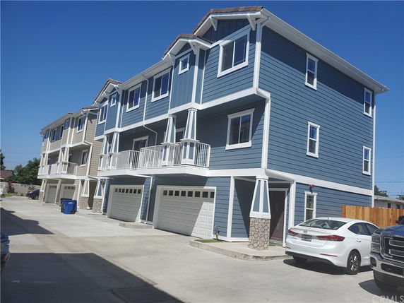 Front view of multi-story residential buildings with attached garages.