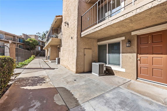 Front view of a two-story apartment building with balconies.
