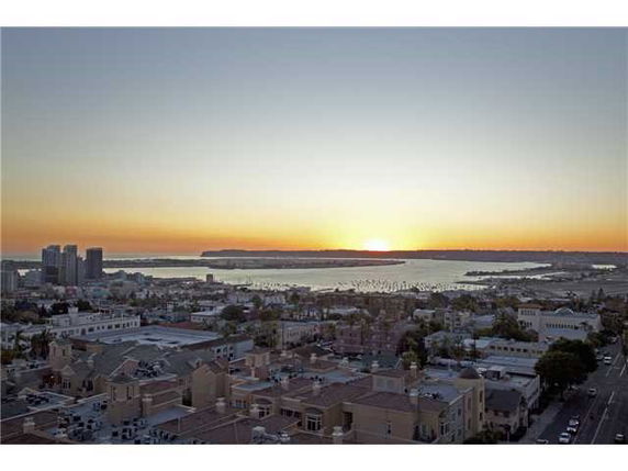 Wide angle view of urban area during sunset with buildings and waterfront.