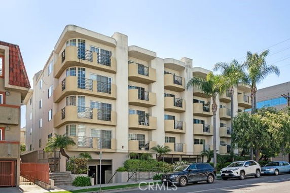 Front view of a multi-story apartment building with balconies.