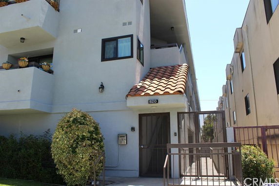 Front view of a multi-story building with balconies.