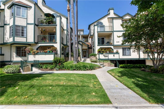 Front view of a multi-story residential building with balconies.