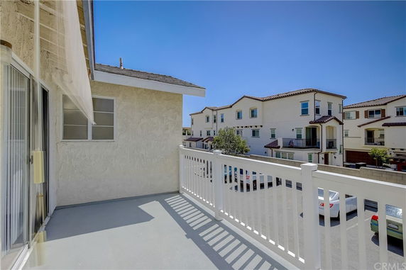 Balcony view showing neighboring multi-story residential buildings.