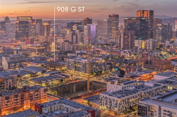 Panoramic view of a cityscape with multiple buildings at sunset.