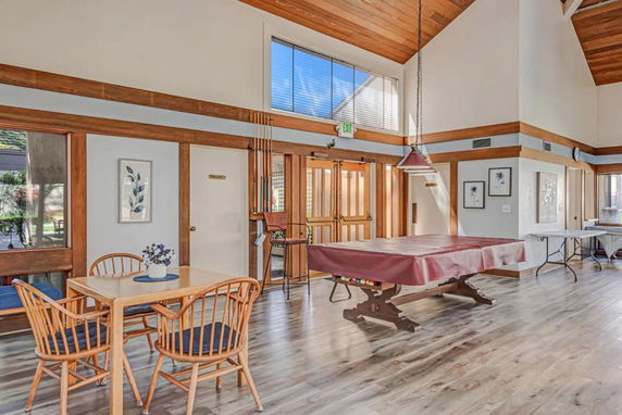 Interior view of a recreational room with a pool table and seating area.