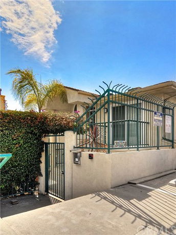 Front view of a residential building with gated entrance.