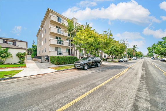 Front view of a multi-story residential building with balconies.