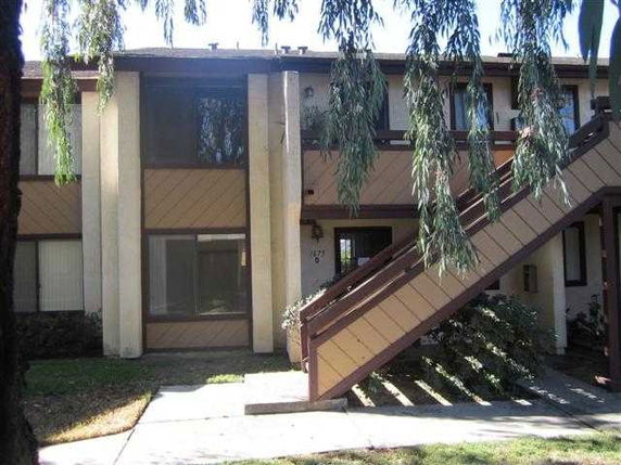 Front view of a two-story building with exterior staircase.
