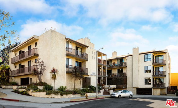 Front view of a multi-story residential building with balconies.