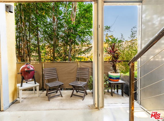 Outdoor seating area with two chairs and a small table.