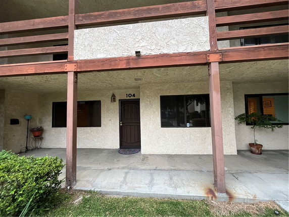 Front view of a ground-level unit with a covered patio entrance.