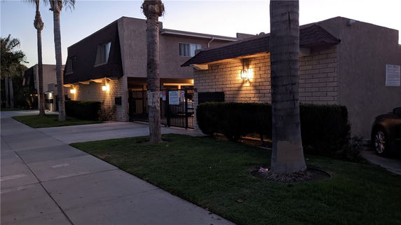 Front view of a two-story building with brick and stucco exterior.