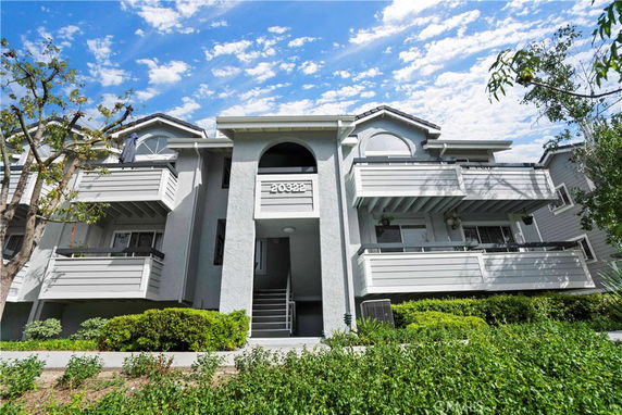 Front view of a multi-story residential building with balconies.