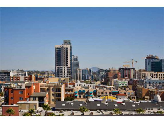 Urban skyline with various buildings, including high-rise and colorful structures.