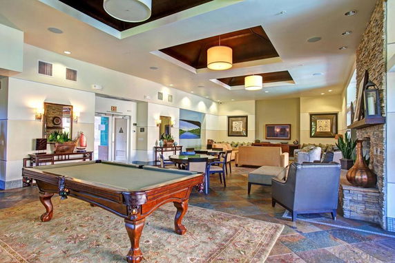 Interior view of a club house with a pool table and seating area.
