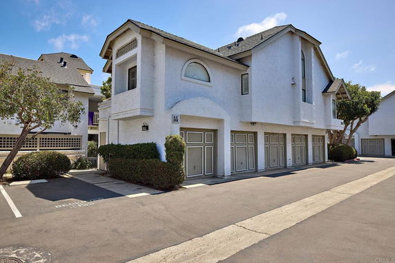 Front view of a multi-story building with multiple garage doors.