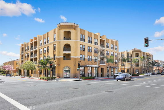 Front view of a multi-story building with retail spaces on the ground floor.