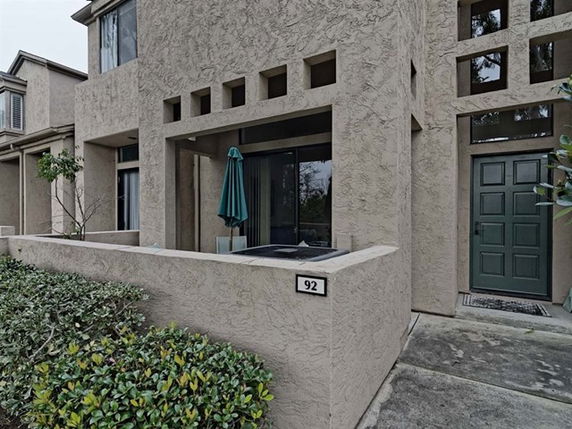Front view of a townhouse with a small porch and a modern design.