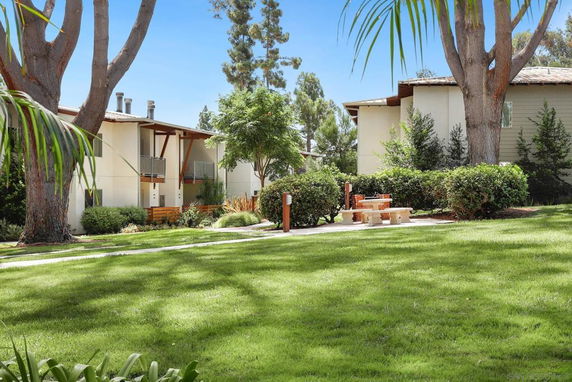 View of surrounding residential area with greenery and outdoor seating.