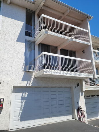 Front view of a house with a garage and balconies.