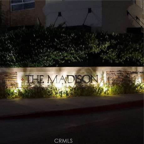 Sign with the words 'The Madison' illuminated at night.