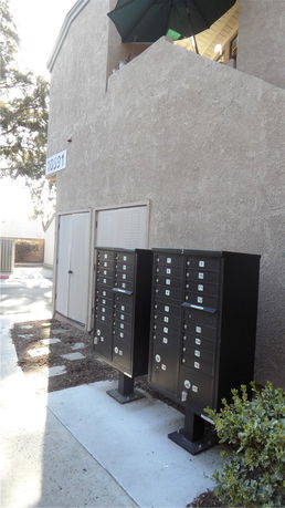 Front view of a building with a mailbox installation and a visible street number.