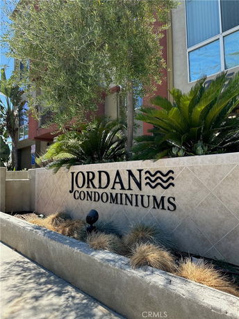 Front view of a condominium building with a sign reading 'Jordan Condominiums'.